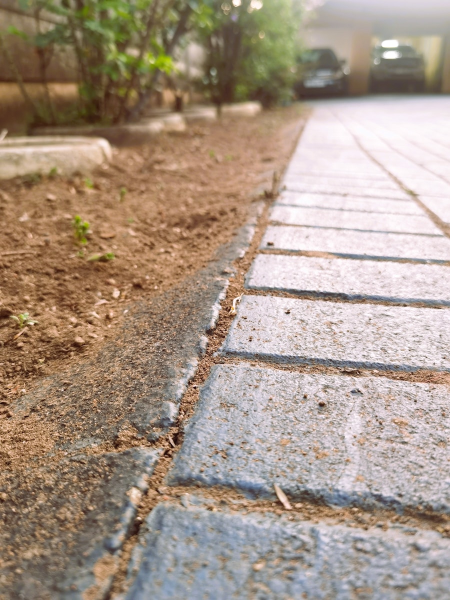 a sidewalk with a car parked in the background